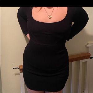 black sweater material dress with corset like detailing on the front.